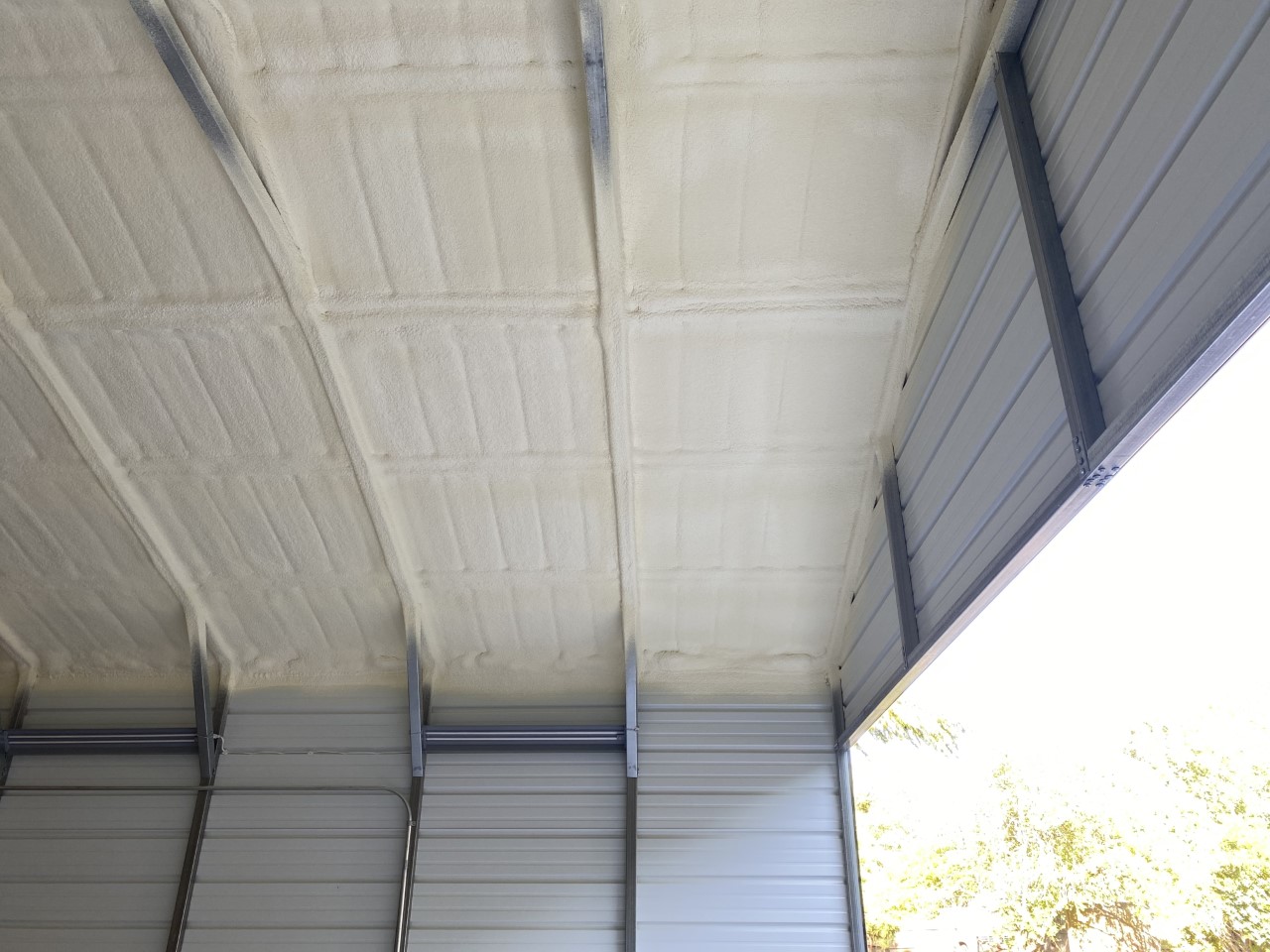Spray foam insulation applied to the roof of a metal building