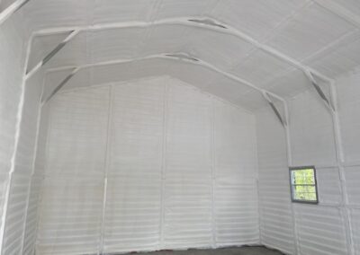 A metal building encapsulated in spray foam by insulation contractors at FoamTech.