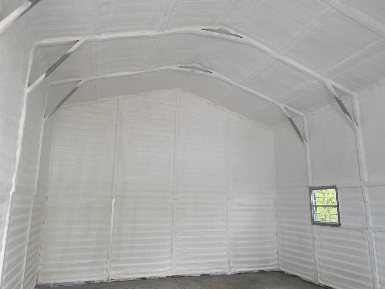 A metal building encapsulated in spray foam by insulation contractors at FoamTech.